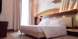 Voodi või voodid majutusasutuse Risorgimento Resort toas