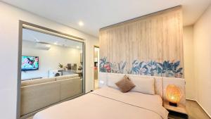 a bedroom with a bed and a large window at Căn hộ The Sóng An Gia - Vũng Tàu Apartment in Vung Tau +146 photos