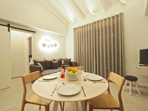 a table with a bowl of fruit on it in a living room at Gaia by Vintage Travel in Ágios Dimítrios