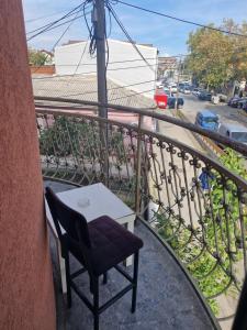 a chair and a table on a balcony at Apartmani Janićijević 1 in Kragujevac