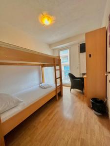 a bedroom with a bed and a desk with a chair at Hostel Herz in Banja Luka +62 photos