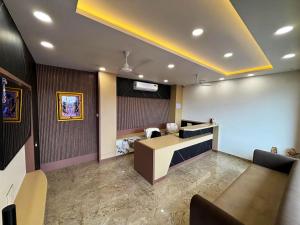 a lobby with a waiting room with a reception desk at Hotel 777 in Akolia