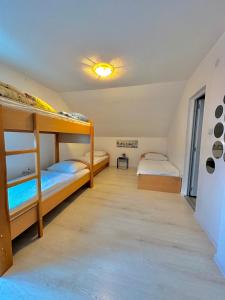 a bedroom with two bunk beds in a room at Hostel Herz in Banja Luka