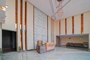 a lobby of a hotel with a couch and a table at Palette - The Mark Club & Resorts in Durg