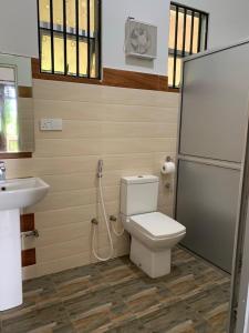 a bathroom with a toilet and a sink at Villa Rukaththana UNAKURUWA in Tangalle