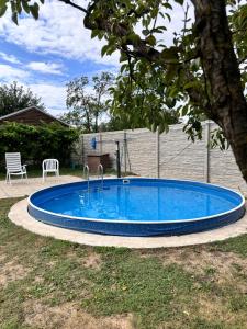 a large blue swimming pool in a yard at Chata 1 in Nový Přerov