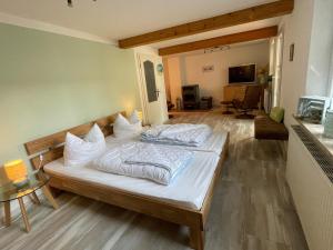 a bedroom with two beds with white pillows at Kleines-Landhaus-Kopendorf in Bojendorf