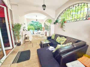 a living room with a couch and a table at Red Clay Apartments City Club in Belgrade