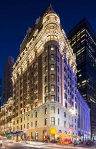 a large building is lit up at night at Dream Midtown in New York