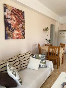 a living room with a couch and a painting on the wall at MARIA Cozy apartment 1 in Pigianos Kampos