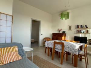 a living room with a table and chairs and a couch at Belvedere Diaz in Calasetta
