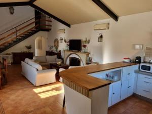 a kitchen and a living room with a fireplace at Finca Campo Alegre in Utrera