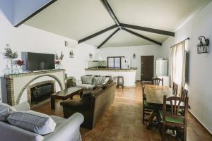 a living room with a couch and a fireplace at Finca Campo Alegre in Utrera +15 photos