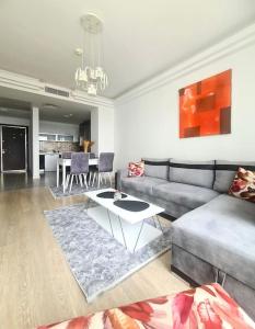 a living room with a couch and a table at 30th Floor-Skyline above a City in Skopje