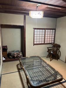 Postel nebo postele na pokoji v ubytování 一日限定一組の古民家の宿なんでもん