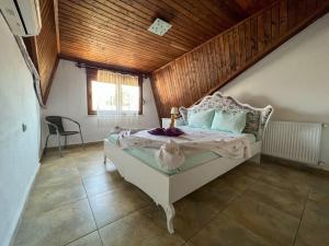 a bedroom with a white bed with a wooden ceiling at Homekemer A in Kemer +34 photos