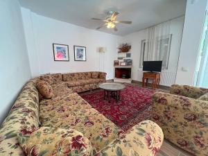 a living room with a couch and a table at Homekemer A in Kemer