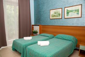 Postel nebo postele na pokoji v ubytování Hotel Victoria