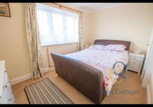 a small bedroom with a bed and a window at Pittlesden Cottage - Sleeps 4 - Tenterden in Tenterden
