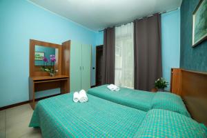 Postel nebo postele na pokoji v ubytování Hotel Victoria