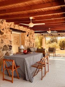 a patio with a table and chairs and a ceiling at Casa en el Valle del Tietar CR-AV-01516 in Fresnedillas