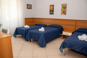Postel nebo postele na pokoji v ubytování Hotel Victoria