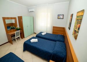 Postel nebo postele na pokoji v ubytování Hotel Victoria