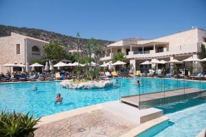 a pool at a hotel with people in the water at Cactus Royal Spa & Resort Adults Only in Stalís