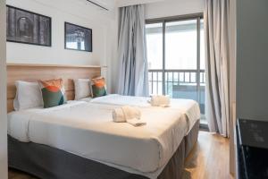 a large bed in a room with a large window at Studio Completo Consolação - Metro Higienopolis-Mackenzie in Sao Paulo +51 photos