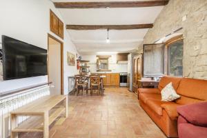 a living room with a couch and a table at La Caseta De Sant Grau in Navés