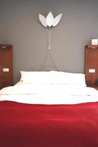 A bed or beds in a room at Delmás Hotel Emblemático
