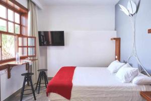 A bed or beds in a room at Delmás Hotel Emblemático