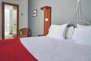 A bed or beds in a room at Delmás Hotel Emblemático