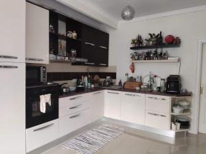 a kitchen with white cabinets and a black microwave at Elegant House in a Small Village in Tur +7 photos