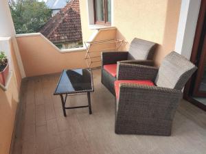 two chairs and a coffee table on a balcony at Elegant House in a Small Village in Tur