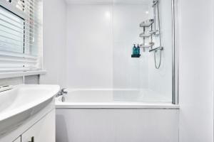 ein weißes Badezimmer mit Dusche und Waschbecken in der Unterkunft Princess Yellow 3 ~ Beautiful Cosy Apt at Harbour in Portrush + 27 Fotos