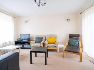 a living room with two chairs and a tv at 3 Bedroom family home Parking Garden - Pass the Keys in Stroud