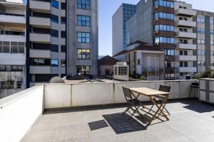 a table and a chair sitting on top of a building at Sena 27 by LovelyStay in Porto