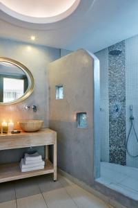 a bathroom with a sink and a shower at Aegean Plaza Hotel in Kamari