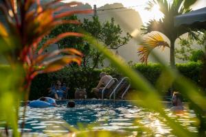 a group of people sitting in a swimming pool at Tam Coc Minh Hung Homestay in Ninh Binh
