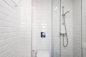 a bathroom with a shower with a toilet at Sena 27 by LovelyStay in Porto +69 photos