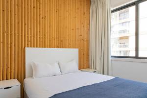 a bedroom with a white bed and a window at Sena 27 by LovelyStay in Porto