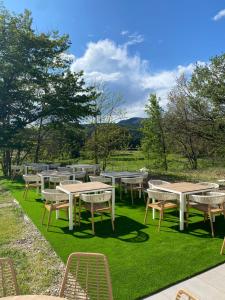 a group of tables and chairs on the grass at Golf Resort de Digne-les-bains by Adonis in Digne-les-Bains