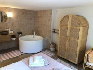 a bathroom with a tub and a sink at Villa de luxe avec piscine au cœur de Hossegor, proche golf, plage et lac - FR-1-791-9 in Soorts-Hossegor +28 photos