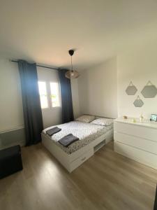 a bedroom with a bed and a window at Maison la Londe in La Londe-les-Maures