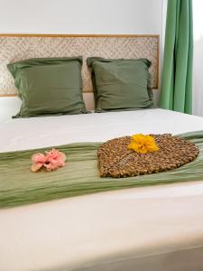 two flowers are sitting on a bed at Ti Kaz des Roches in Saint-Louis
