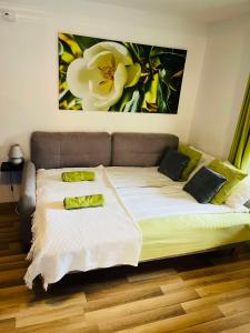 a bed with two pillows on it in a room at Bálics Vendégház in Pécs +33 photos