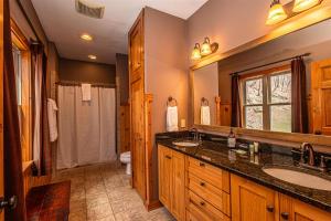 a bathroom with two sinks and a toilet at Millstone Lodge in Bryson City +42 photos