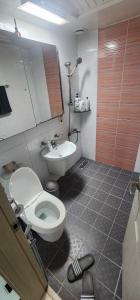 a bathroom with a toilet and a sink at 3 bedroom apartments in Incheon