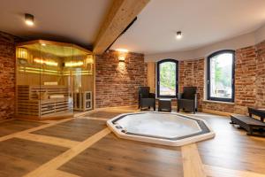 a large room with a hot tub in a brick wall at Villa na pagórku Limanowa in Mordarka